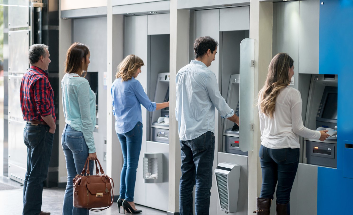 People in a line at an ATM