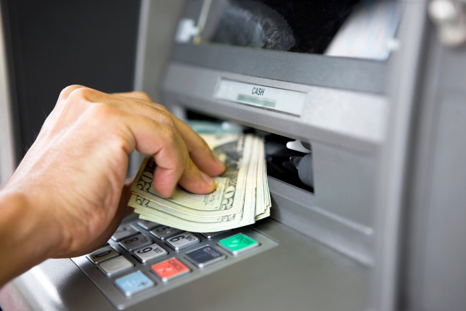 Taking money from ATM machine